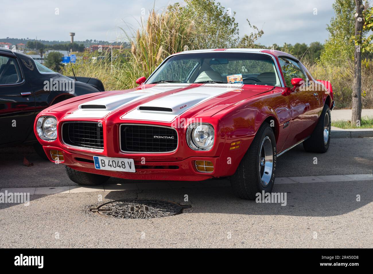 Front view of a classic red American sports muscle car with white