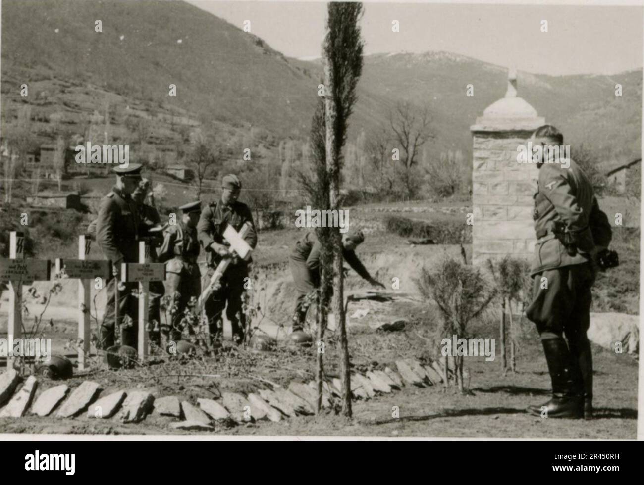 Gunter Alquen (Leibstandarte Adolf Hitler, Greece 1941), an SS photographer, documented Nazi atrocities in Greece during World War II. His lens captured the horror and suffering inflicted upon innocent civilians and resistance fighters.  Images of Sepp Dietrich, accompanied by officers, captured in photographs alongside soldiers, Greek soldiers and civilians, Greek countryside, buildings, pontoon bridge operations. Numerous vehicles bearing tactical symbols, along with the aftermath of destruction: ruined buildings, vehicles, equipment. Artillery shelling and scenes depicting a war-torn countr Stock Photo