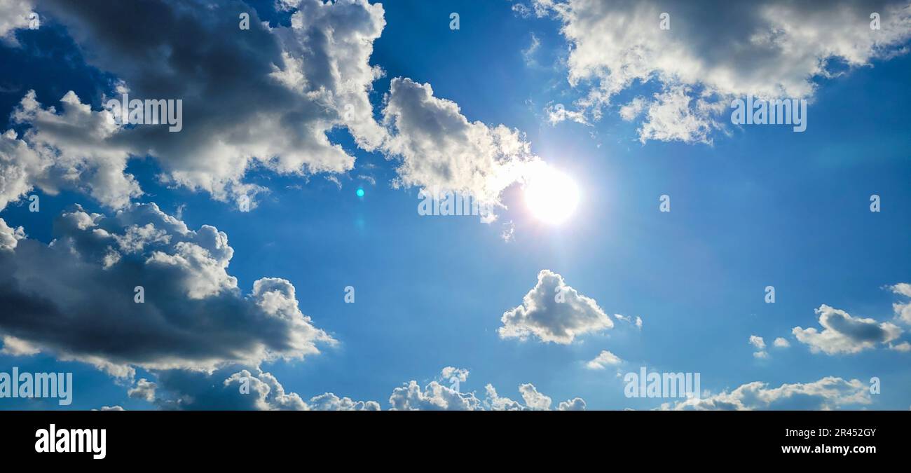 A beautiful blue sky with white, fluffy clouds and a stunning golden ...
