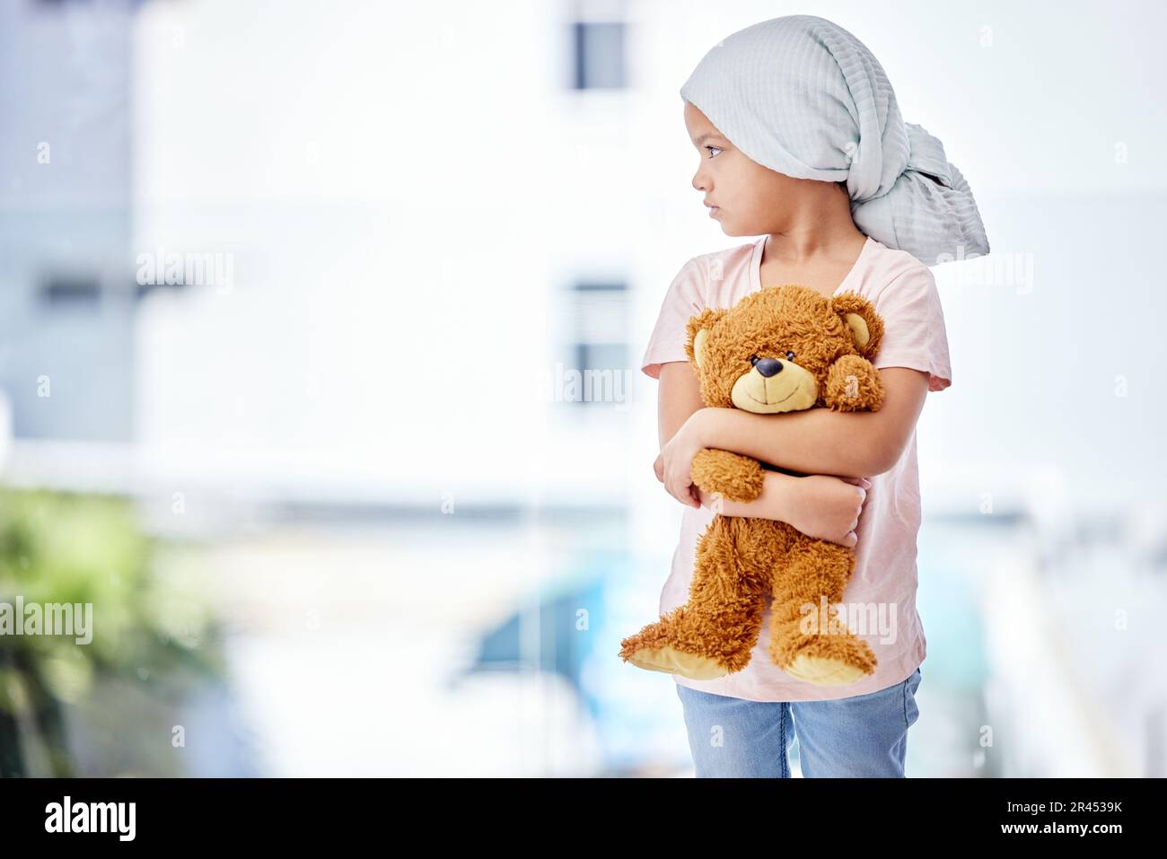 Healthcare, teddy bear and child cancer patient holding her toy for