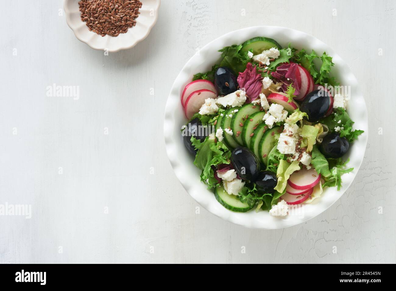 Lettuce salad, cucumber, radish salad with cottage cheese and flax