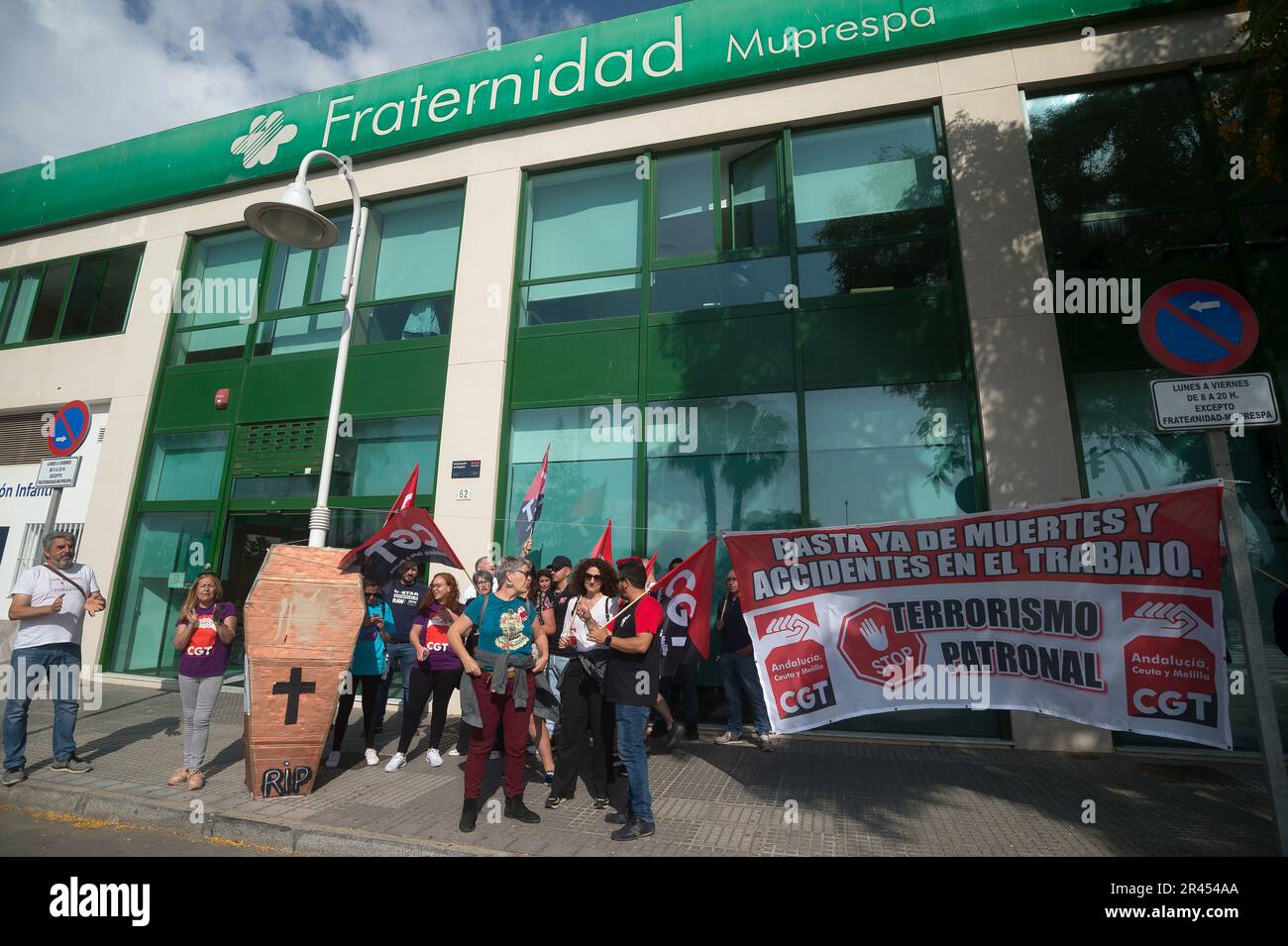 Malaga, Spain. 26th May, 2023. Protesters are seen holding flags and a large banner during a protest against workplace accidents in front of a mutual insurance company, before taking part in a tribute to workers who died in labor accidents in the year 2022 in Andalusia. Dozens of people called by the General Workers Conference demonstrated to demand safety measures and accident prevention in the workplace, along with a symbolic homage at the beach. Credit: SOPA Images Limited/Alamy Live News Stock Photo