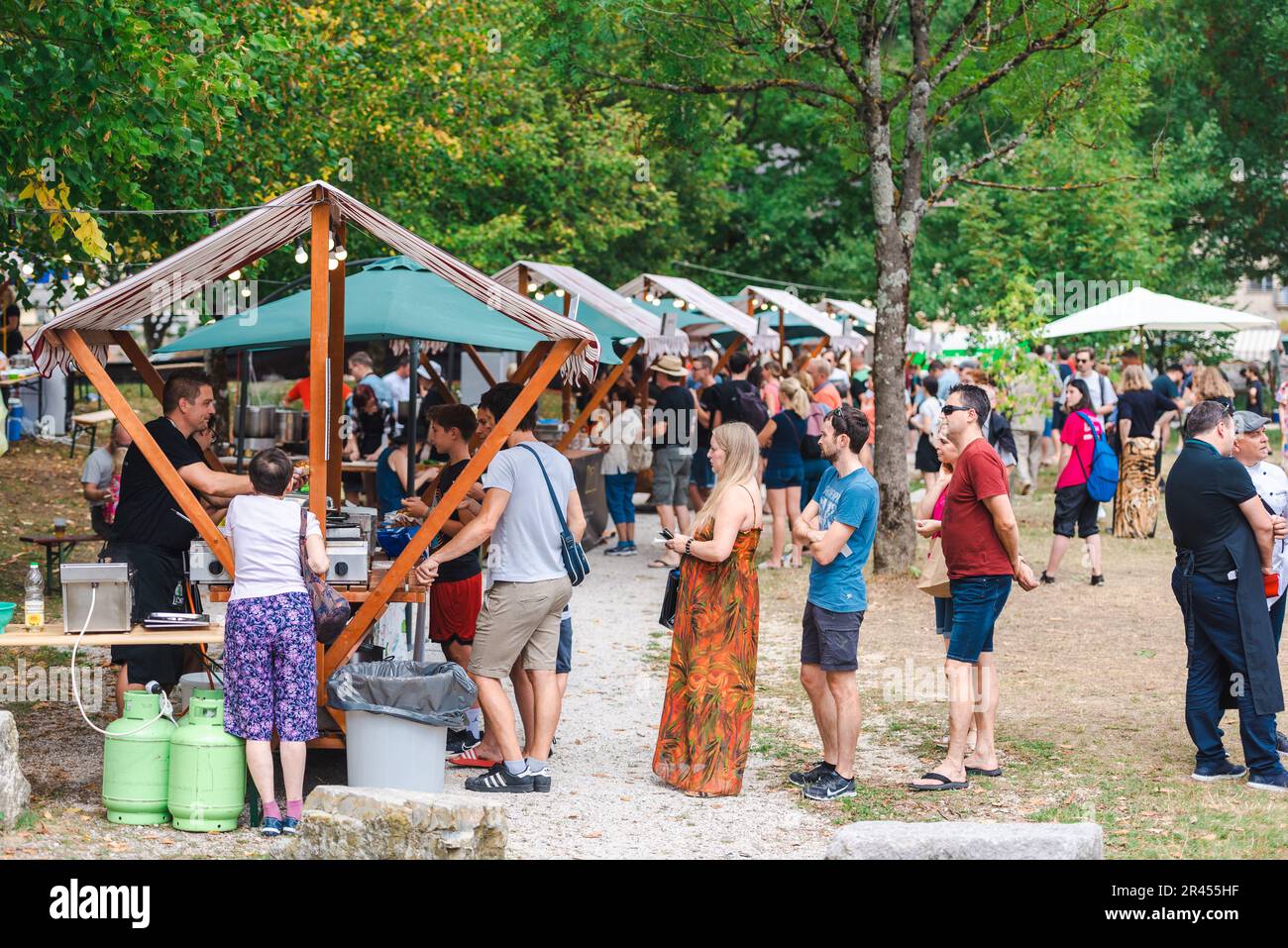 People in line waiting for traditional food zlikrof in festival in Idrija Stock Photo
