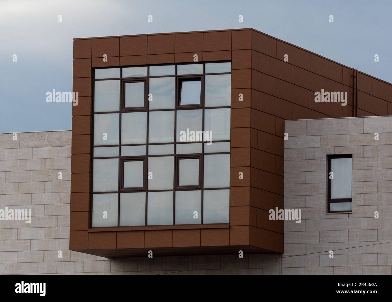 An image of a modern business building featuring a tall glass window ...