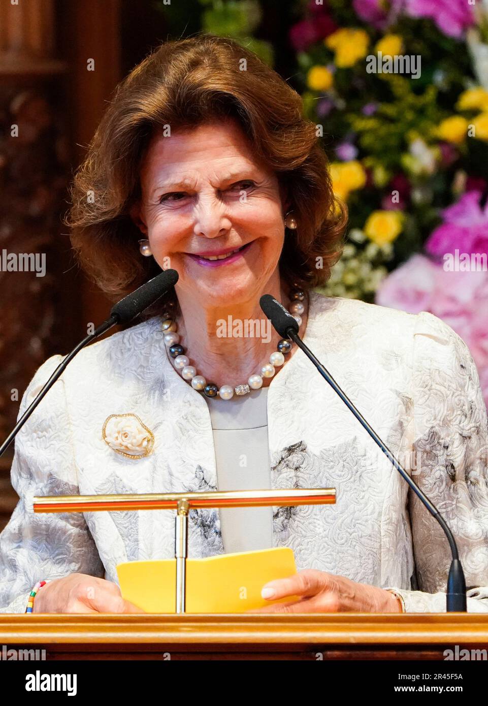 Sweden's Queen Silvia makes a speech as she receives the certificate of
