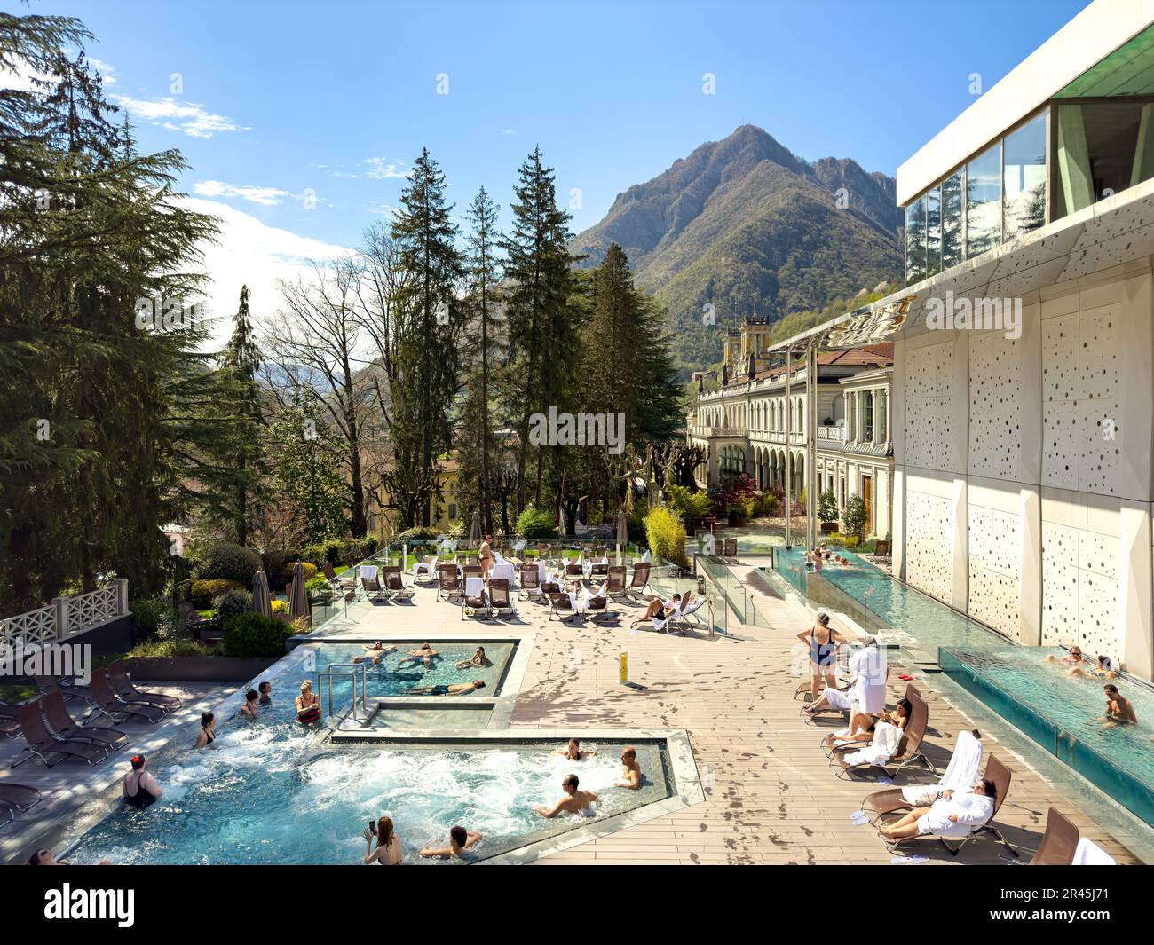 Guests enjoying the outdoor pools at the QC San Pellegrino Spa in Bergamo, Italy Stock Photo