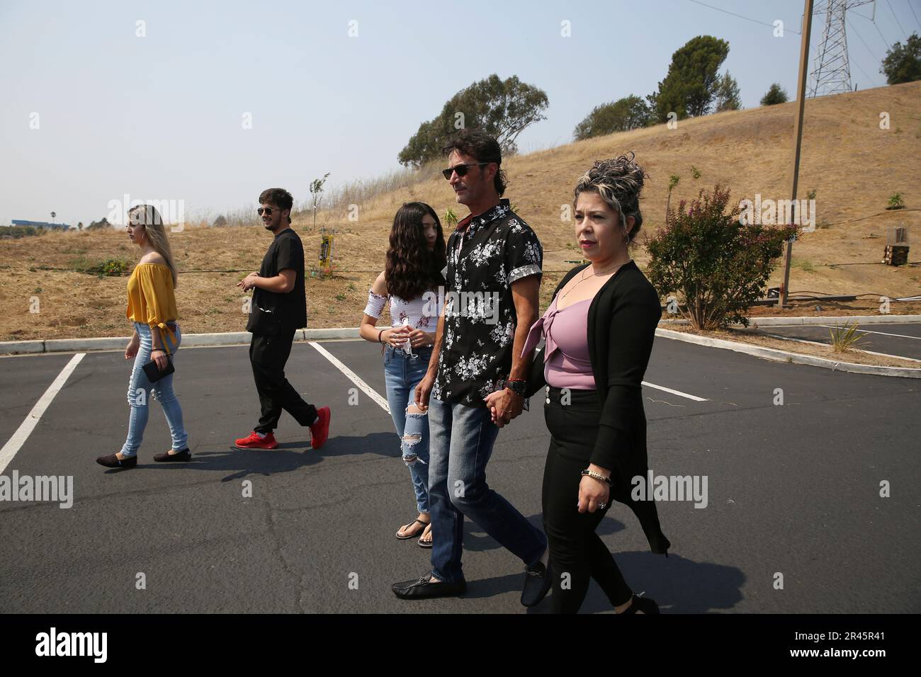 Jose Villalobos (second from right) and his wife Maria Villalobos (right)  hold hands as they walk with their children Fernanda Villalobos (center),  14; Rodolfo Villalobos (second from left), 20; and Mariana Villalobos (
