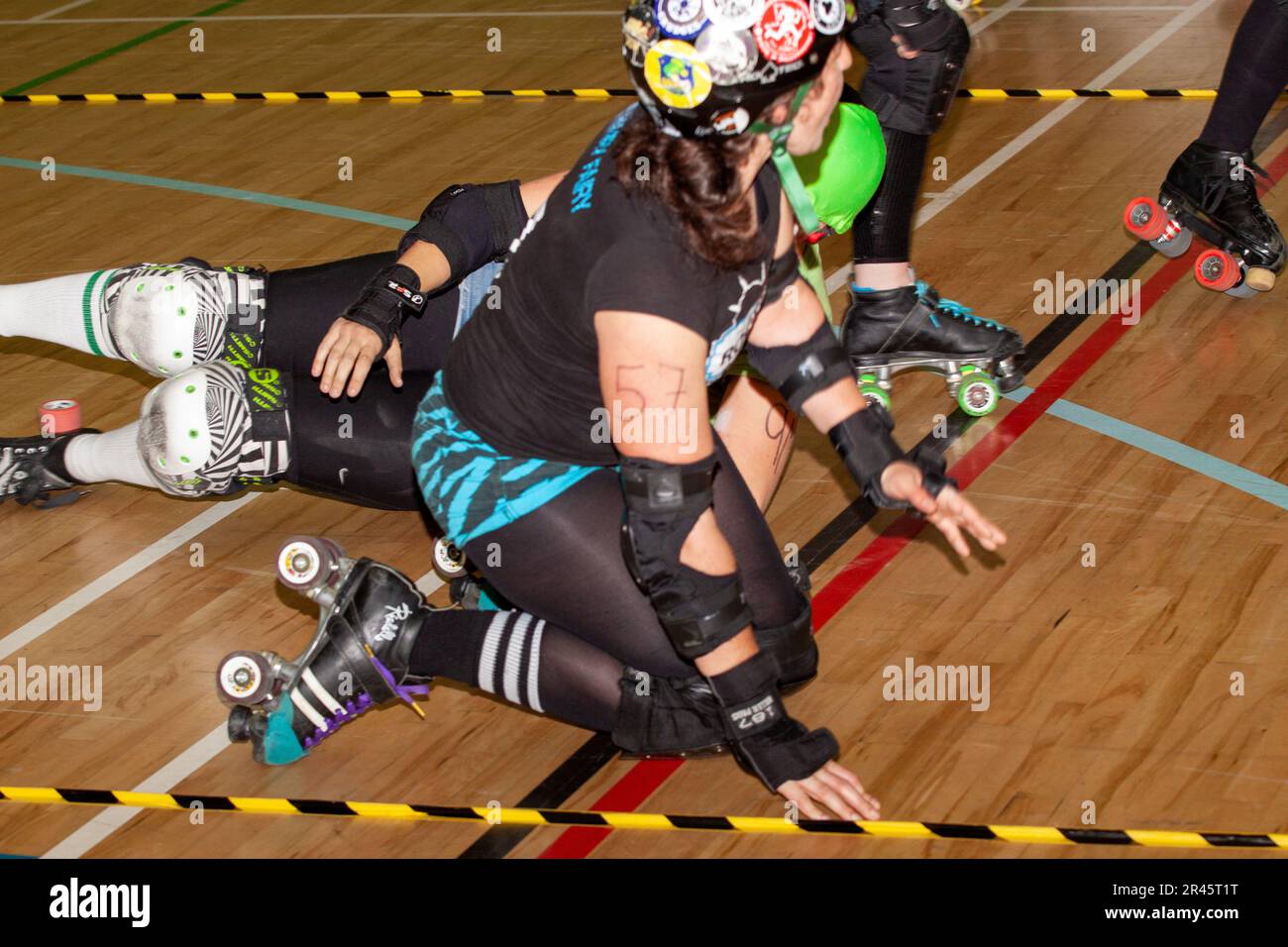 Downed roller derby skaters during a bout at the Kelsey Kerridge sports centre Cambridge Stock Photo