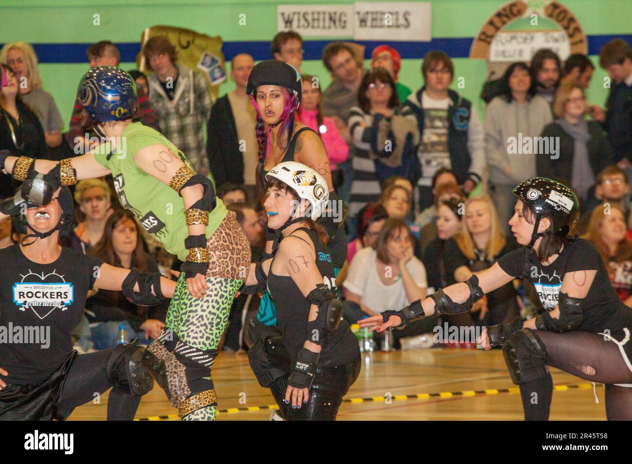 Old school roller derby two whistle start with one team's blockers