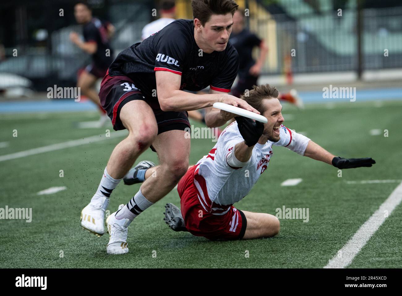Toronto, Canada. 20th May, 2023. Rush player Phil Turner catches the disc under defensive pressure from Breeze player David Cranston, during a Toronto Rush vs. DC Breeze game of ultimate in the American Ultimate Disc League (AUDL), at Varsity Stadium, in Toronto, ON, Canada, on May 20, 2023. (Graeme Sloan/Sipa USA) Credit: Sipa USA/Alamy Live News Stock Photo