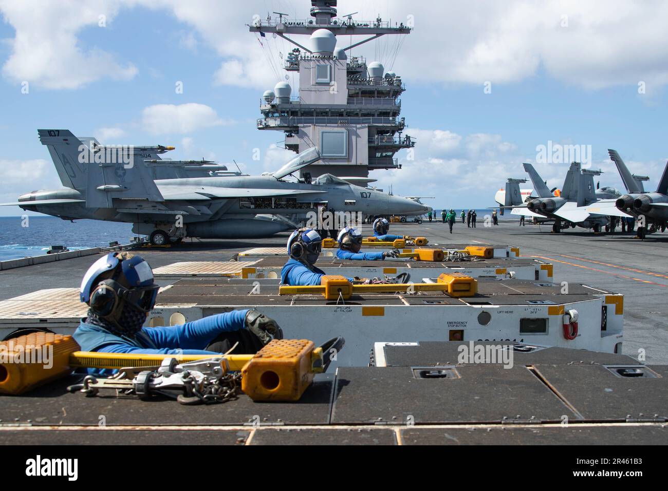 Sailors, assigned to the first-in-class aircraft carrier USS Gerald R. FordÕs (CVN 78) air department, line up spotting dollys on the flight deck, March 24, 2023. Ford is underway in the Atlantic Ocean executing its Composite Training Unit Exercise (COMPTUEX), an intense, multi-week exercise designed to fully integrate a carrier strike group as a cohesive, multi-mission fighting force and to test their ability to carry out sustained combat operations from the sea. As the first-in-class ship of Ford-class aircraft carriers, CVN 78 represents a generational leap in the U.S. NavyÕs capacity to pr Stock Photo