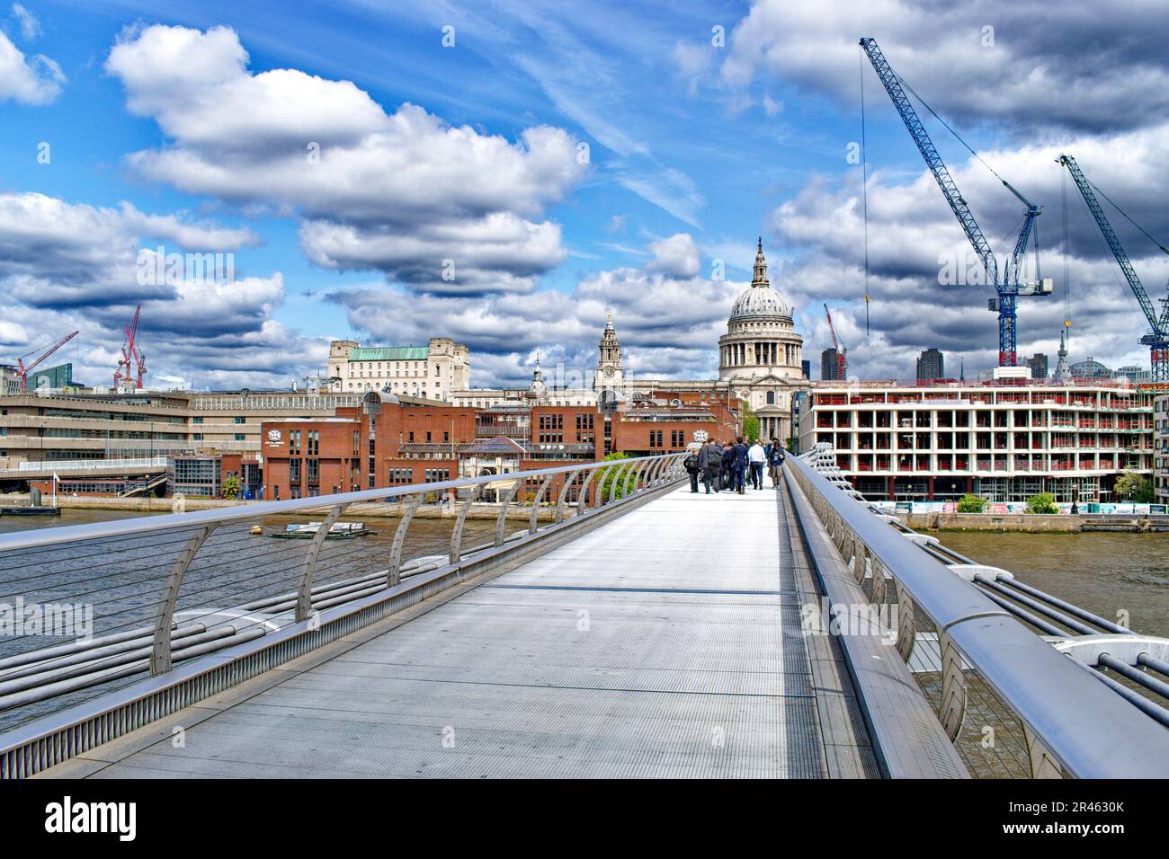 London St Pauls Cathedral the Millennium Footbridge with cranes and new buildings Stock Photo