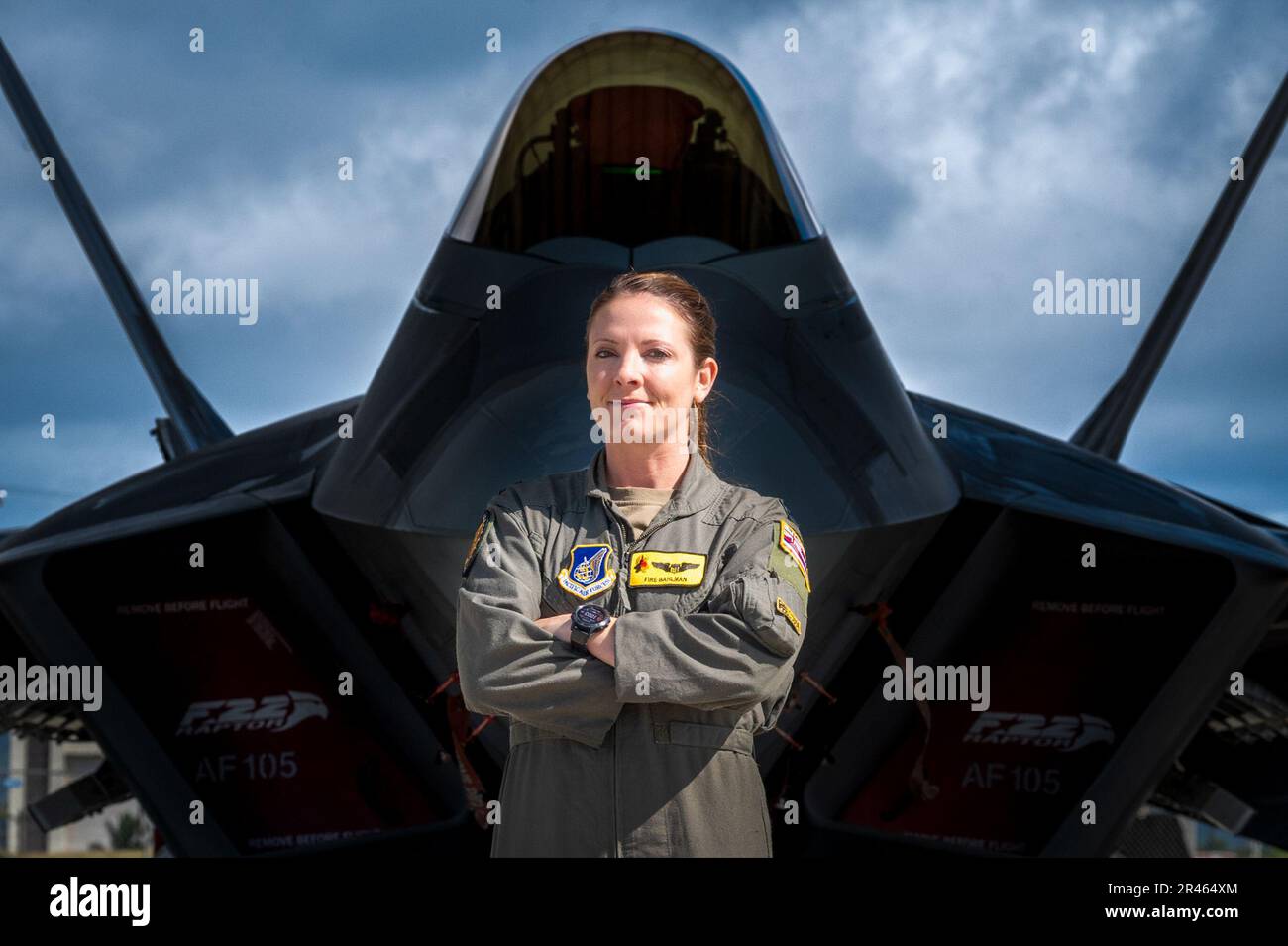 U.S. Air Force Capt. Nichole Bahlman, 199th Fighter Squadron F-22 Raptor pilot, poses in front of her aircraft prior to take-off during a routine training mission Joint Base Pearl Harbor-Hickam, Hawaii, Mar 14, 2023. Capt. Bahlman is the first female fighter pilot in the Hawaii Air National Guard. Stock Photo