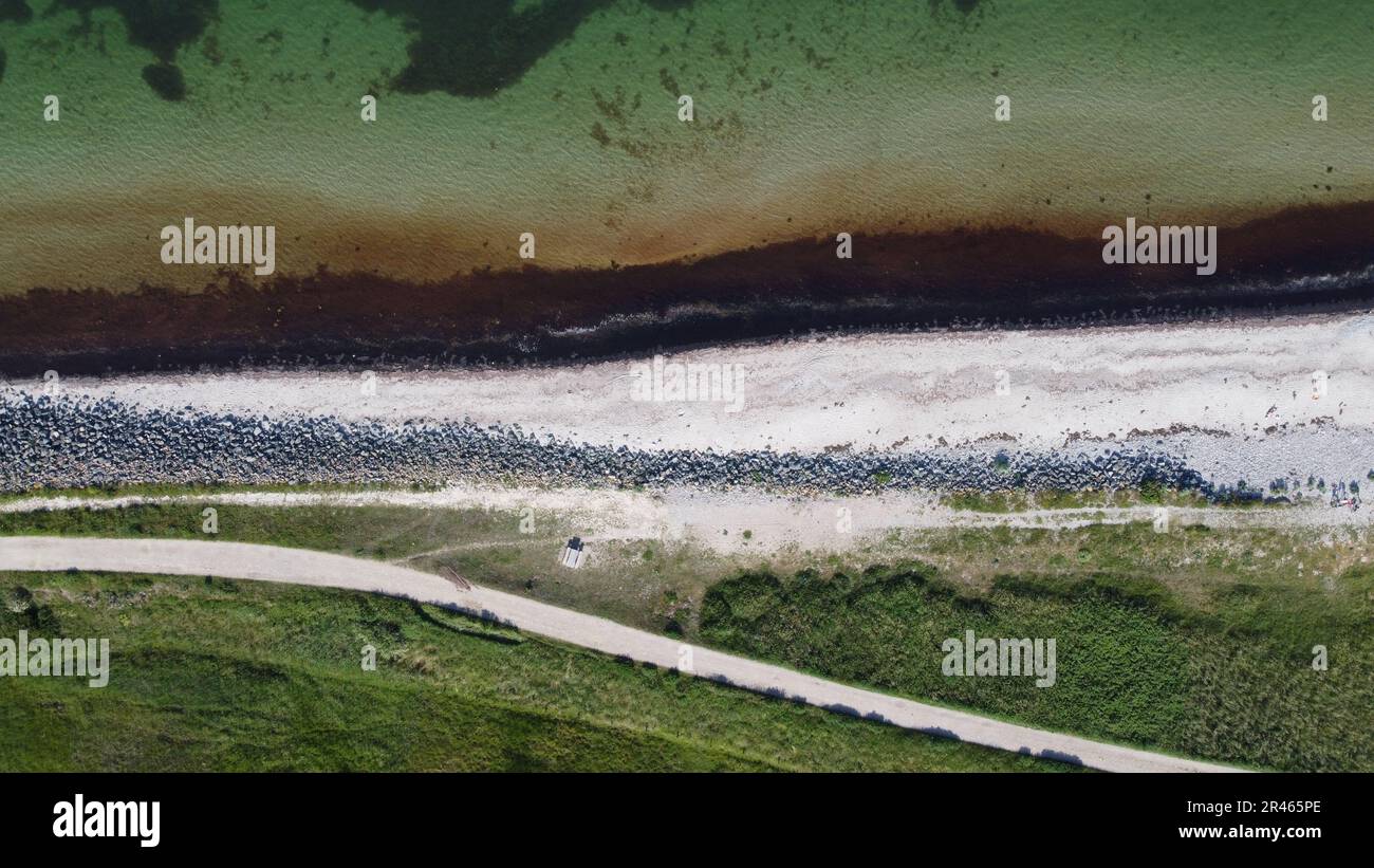 Aerial view of a stunning coastal landscape featuring a green and rocky ...