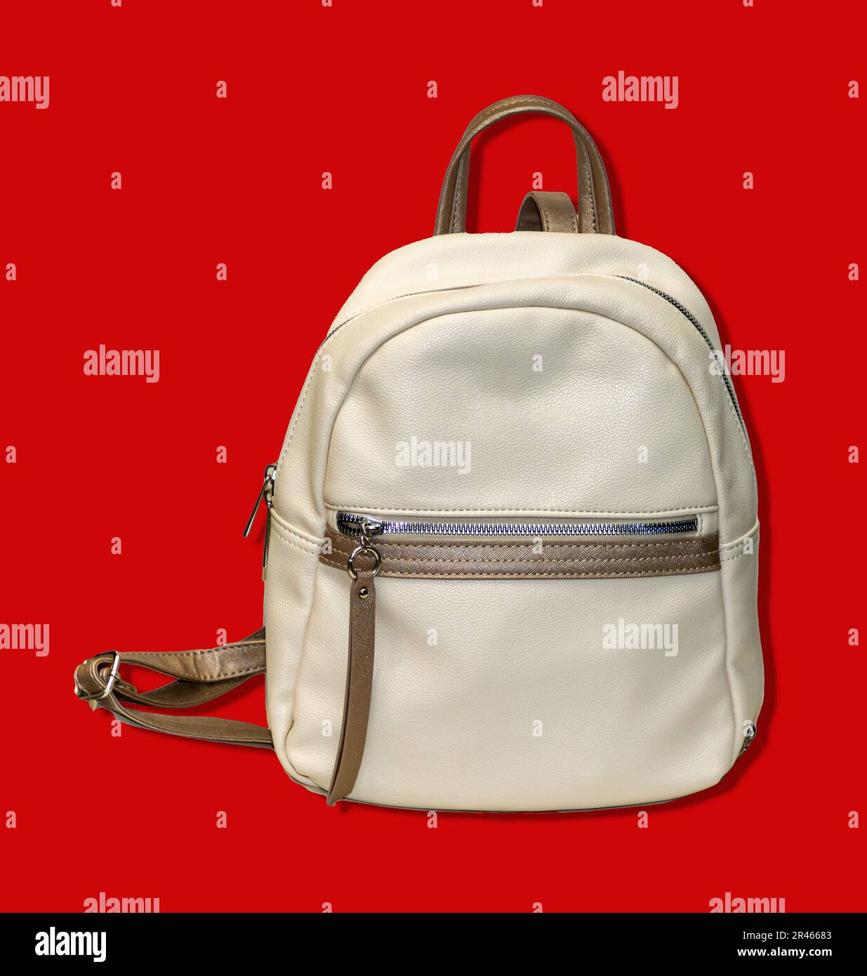 Modern white leather material closed backpack isolated on red background Stock Photo
