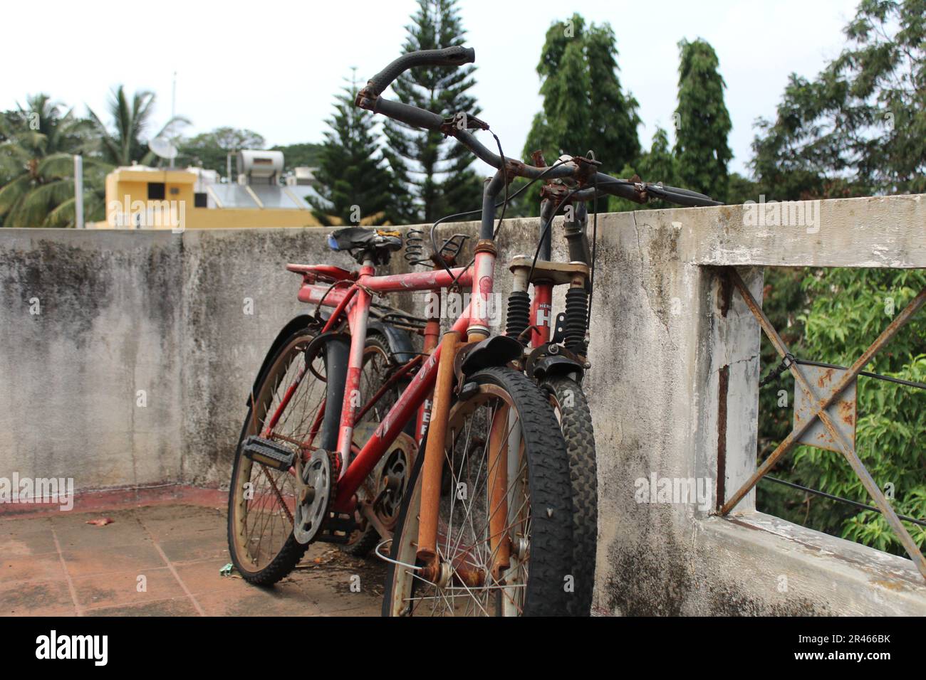 An abandoned bicycle on a rooftop in the city of Bangalore, India. Stock Photo