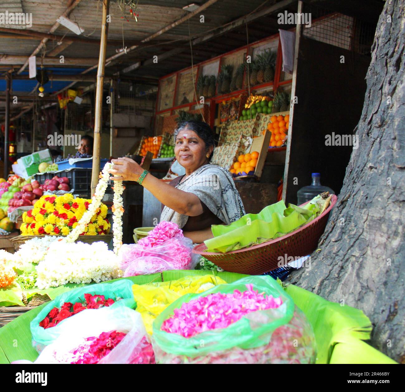 An old lady sells flowers on the streets of Malleshwaram in Bengaluru. Stock Photo