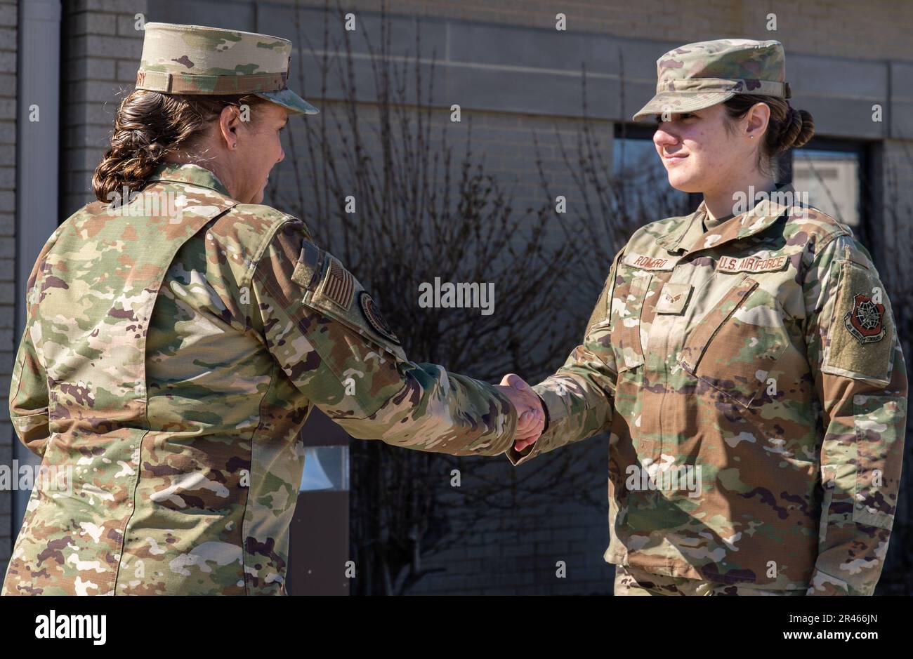 Maj. Gen. Linda Hurry, left, Director of Logistics, Deputy Chief of Staff for Logistics, Engineering and Force Protection, Headquarters U.S. Air Force, the Pentagon, Arlington, Virginia, coins Senior Airman Gracie Romero, right, 436th Aerial Port Squadron cargo processor, during her visit at Dover Air Force Base, Delaware, March 20, 2023. Hurry’s visit focused on the 436th Mission Generation Group’s innovation integration, resiliency and theory of constraints. The general wanted to check in with the Airmen, ask how they are doing and what HAF/A4L can do for them. Stock Photo