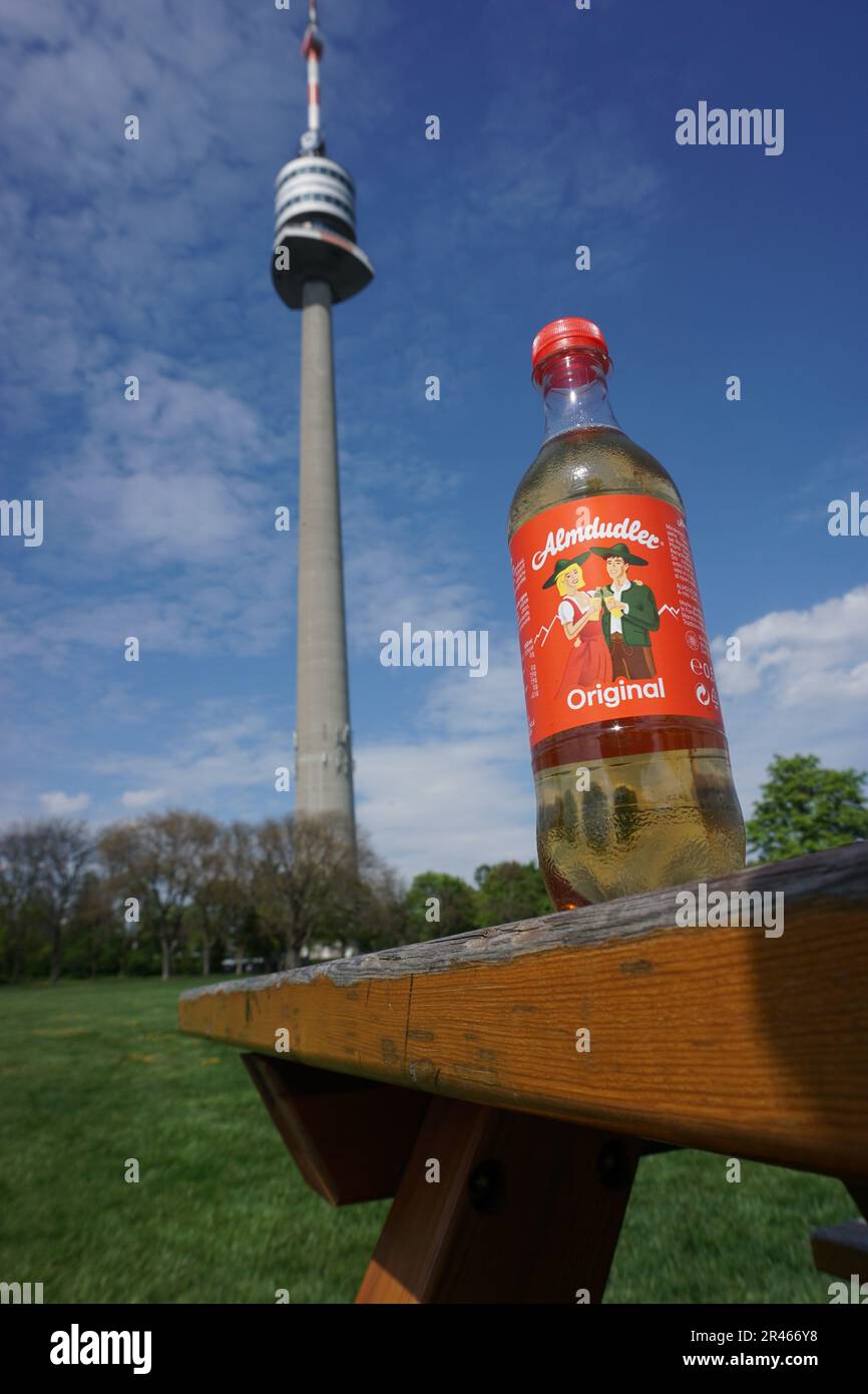 A bottle of Almdudler with the Danube Tower, Vienna, in the background Stock Photo