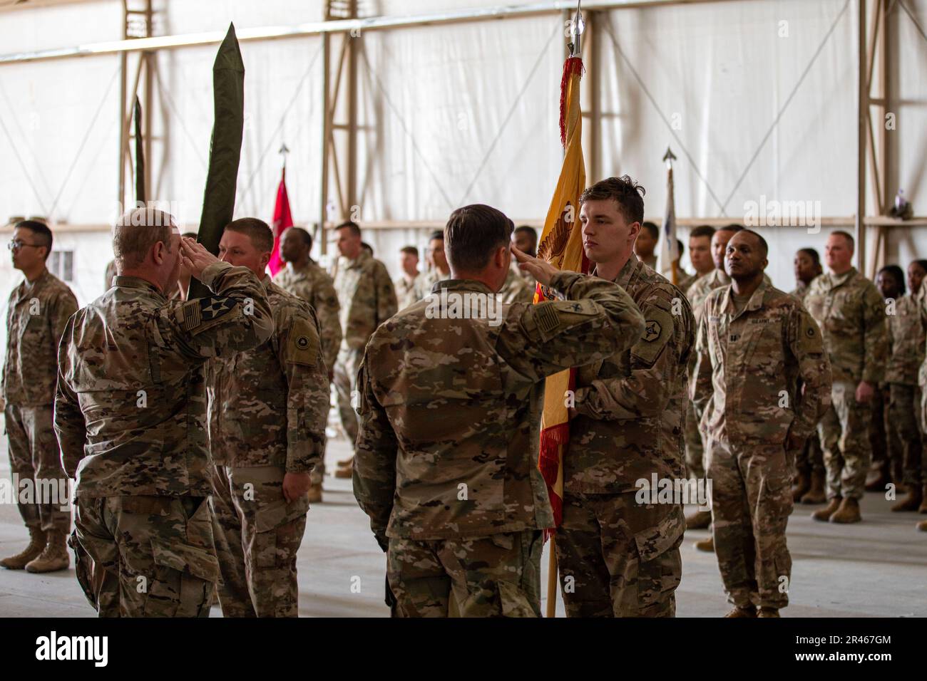 U.S. Army Lt. Col. Scott Eberle and Command Sgt. Maj. Shaun Collins, the command team of the 382nd Combat Sustainment Support Battalion, render a salute at they uncased their battalion colors during a ceremony in which the 336th CSSB transfers authority to the 382nd. These battalions are subordinate to the 369th Sustainment Brigade while forward deployed to the CENTCOM area of operations. Stock Photo