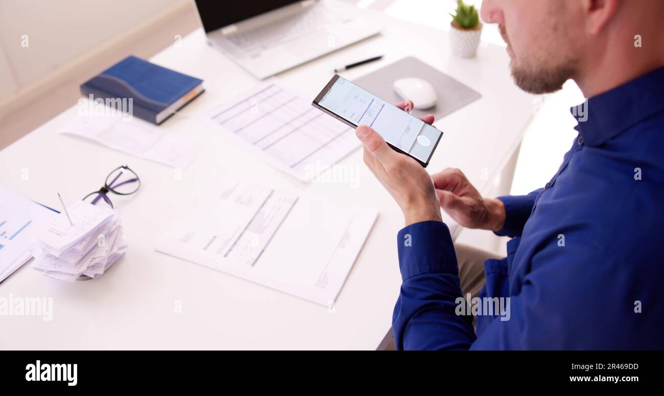 Taking Invoice Document Photo Using Phone Or Smartphone Stock Photo