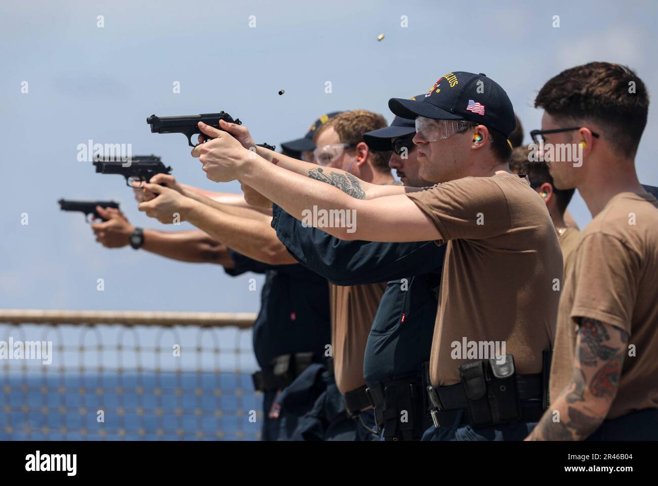 SOUTH CHINA SEA (March 27, 2023) – Sailors assigned to the Arleigh Burke-class guided-missile destroyer USS Milius (DDG 69) fire 9 mm pistols during a live-fire exercise while operating in the South China Sea, March 27. Milius is assigned to Commander, Task Force 71/Destroyer Squadron (DESRON) 15, the Navy’s largest forward-deployed DESRON and the U.S. 7th Fleet’s principal surface force. Stock Photo