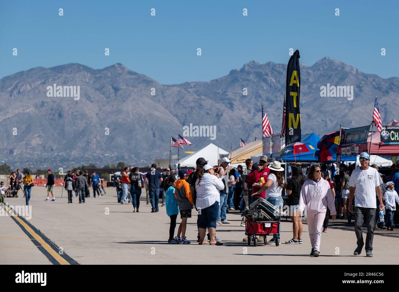 Air show attendees walk up and down the flight line filled during the