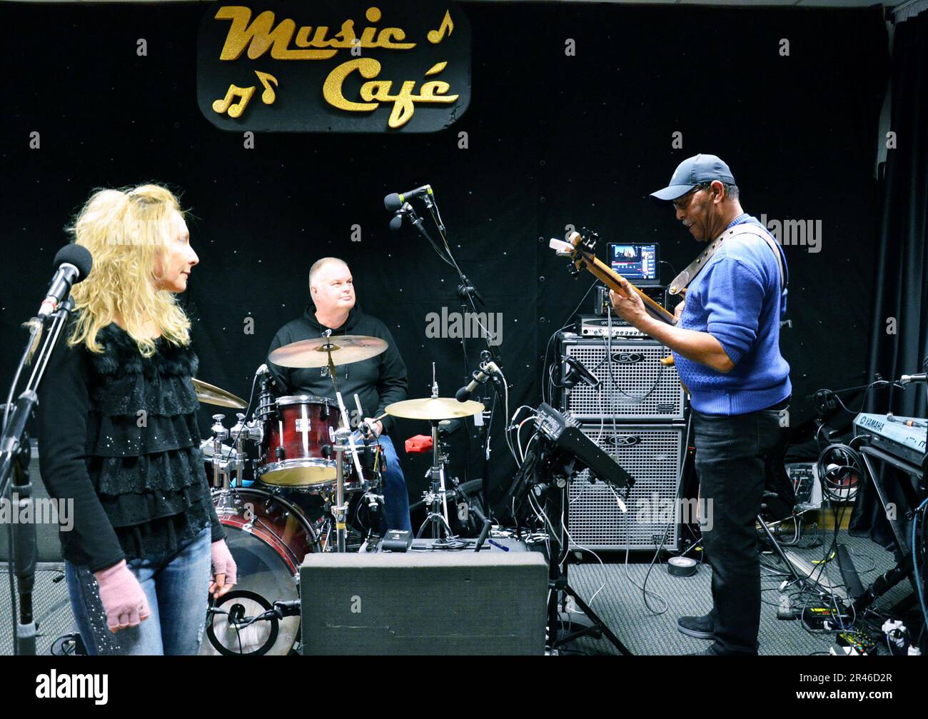 VICENZA, Italy - Barry Robinson, music director, right, plays his bass alongside other musicians, while checking the sound system for the first edition of Music Café Jan. 22, 2023. The monthly event returns to Soldiers’ Theatre after a two-year break for the pandemic. Stock Photo