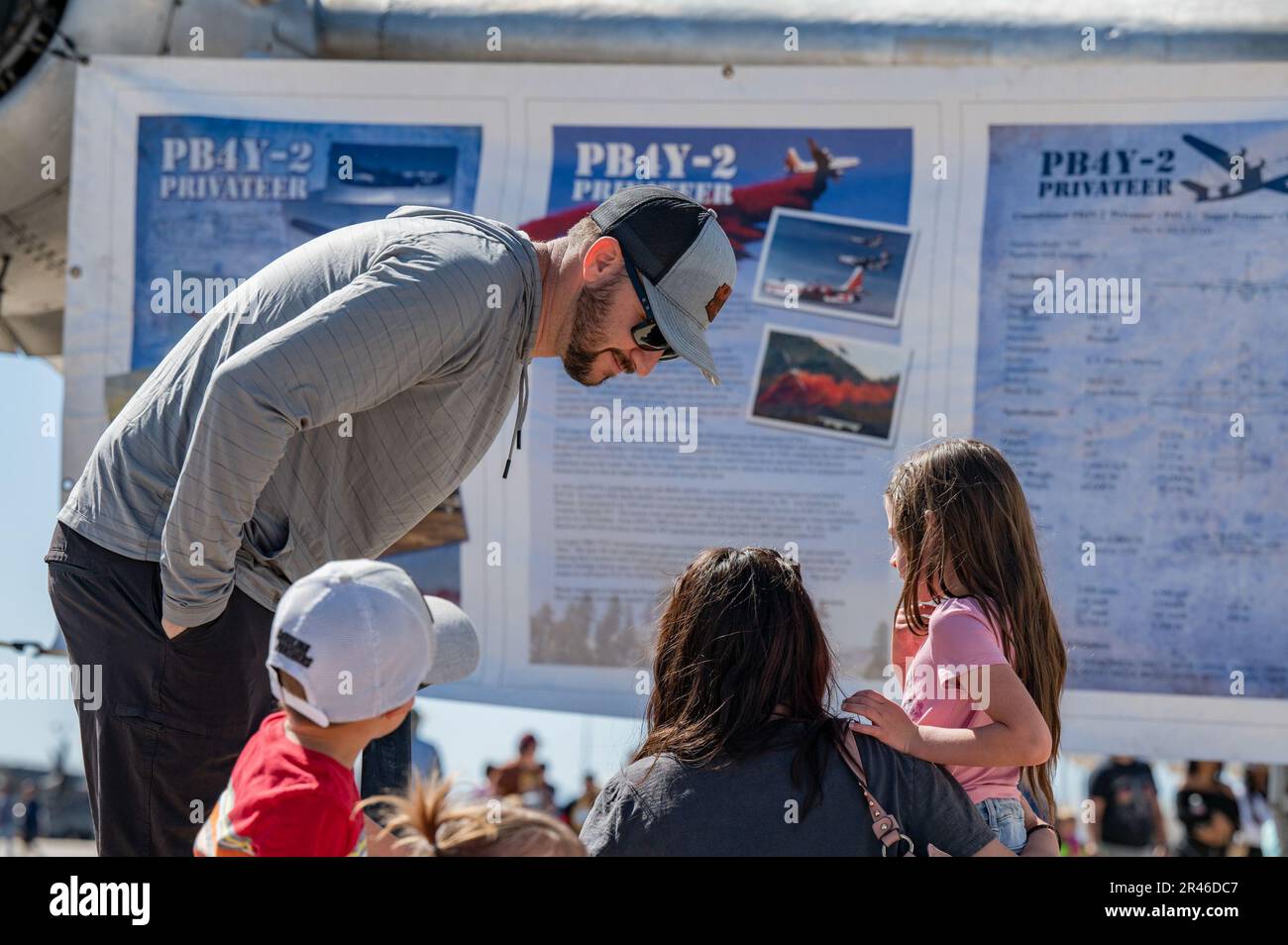 Air show attendees look at the static display information sheet of an