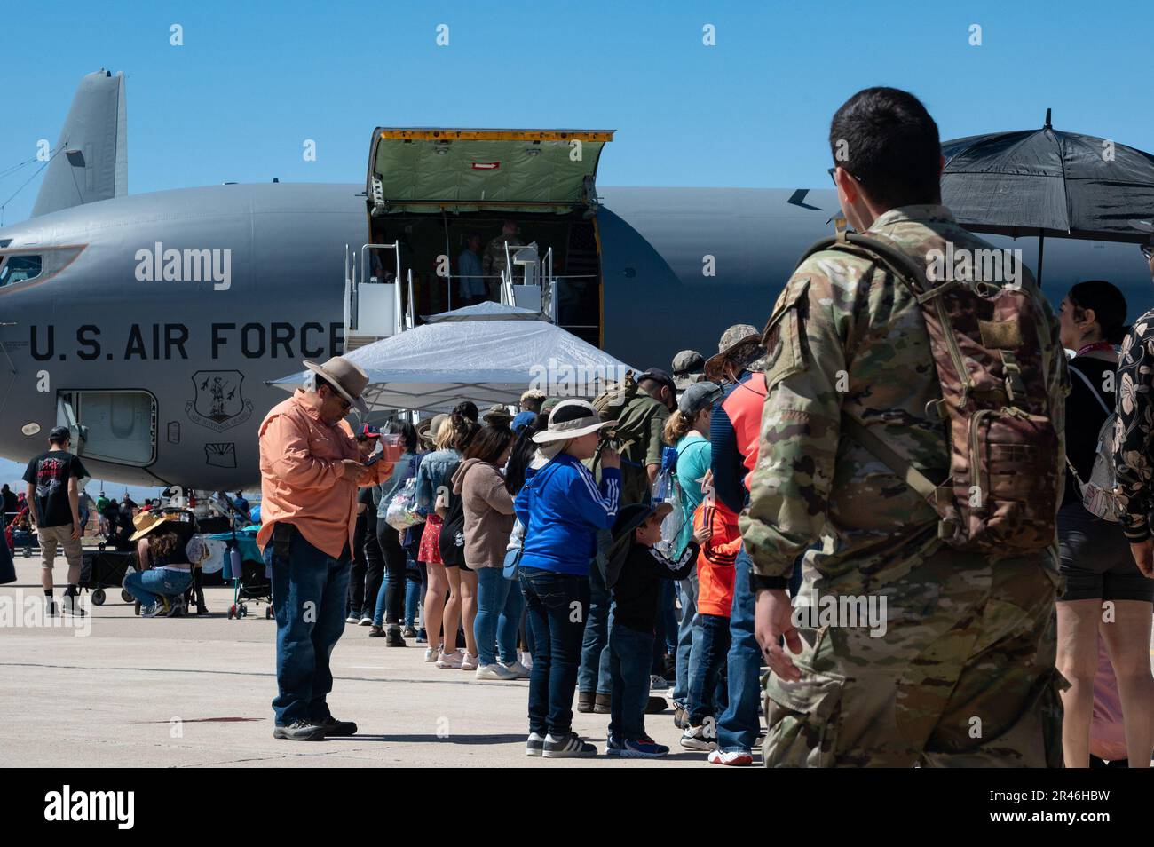 Air show attendees stand in line for a static display aircraft during