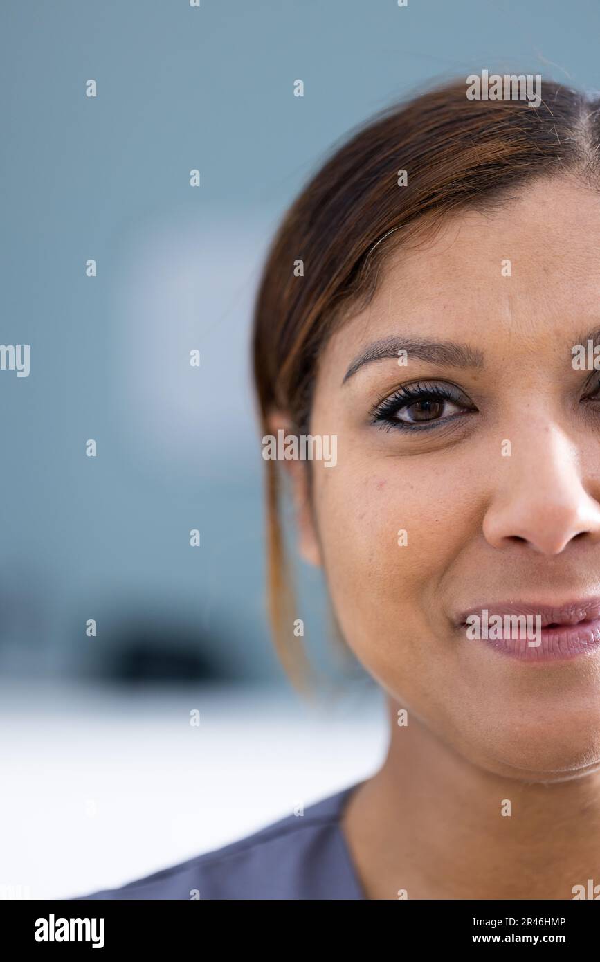 Unaltered portrait of half face of happy asian female doctor smiling in hospital, copy space Stock Photo