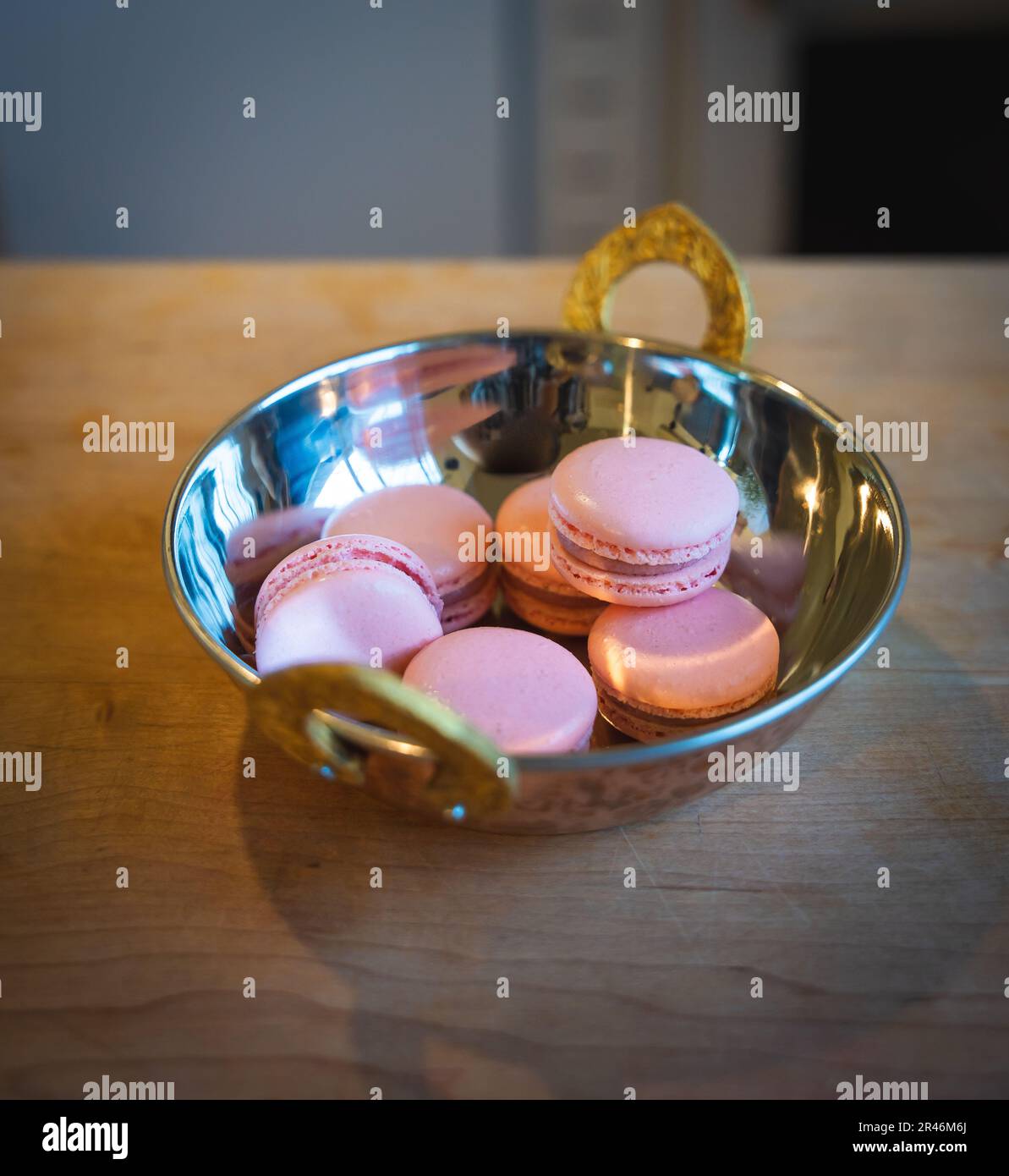 Pink macaroons on a golden plate Stock Photo