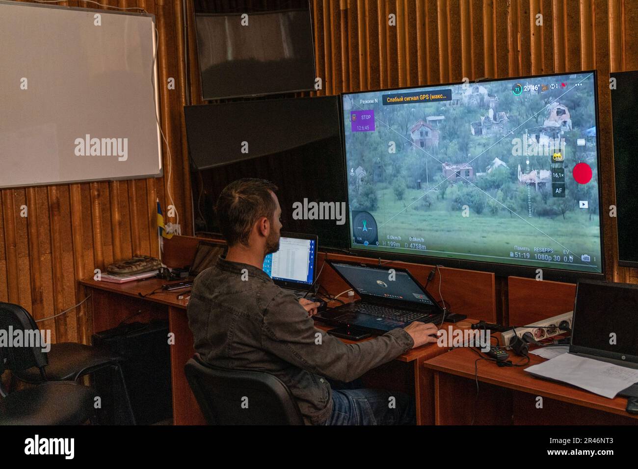 Member of Special Ukrainian army unit operating reconnaissance drones monitors on screen views of positions of Russian forces using Starlink technology in undisclosed location in Donbas of Ukraine on May 26, 2023 Stock Photo