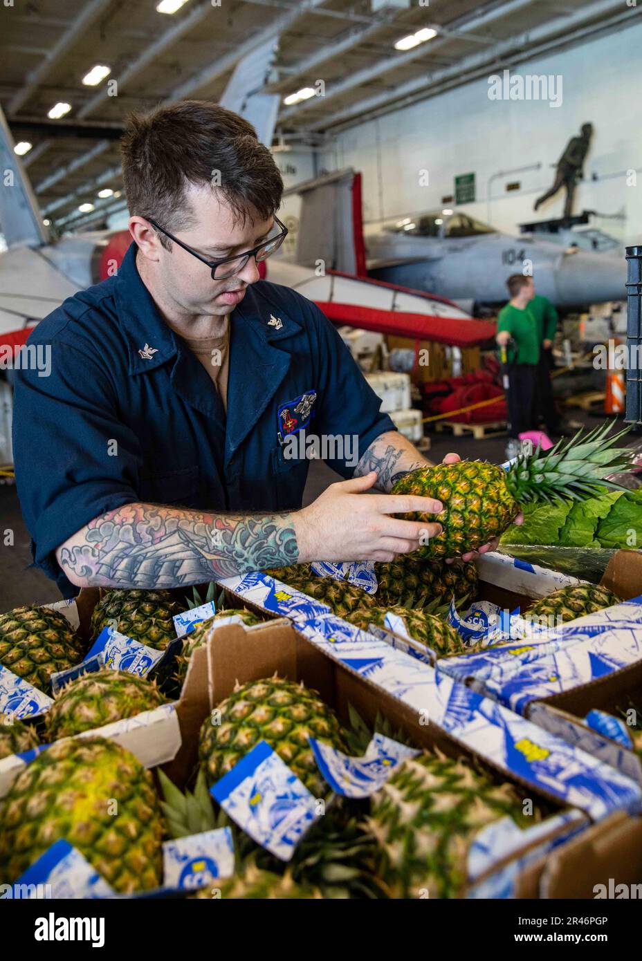 230401-N-IX644-1013 IONIAN SEA (April 1, 2023) Hospital Corpsman 2nd Class Sean Harris, assigned to the Nimitz-class aircraft carrier USS George H.W. Bush (CVN 77), inspects produce during a replenishment-at-sea with the Supply-class fast combat support ship USNS Arctic (T-AOE 8), April 1, 2023. The George H.W. Bush Carrier Strike Group is on a scheduled deployment in the U.S. Naval Forces Europe area of operations, employed by U.S. Sixth Fleet to defend U.S., allied, and partner interests. Stock Photo