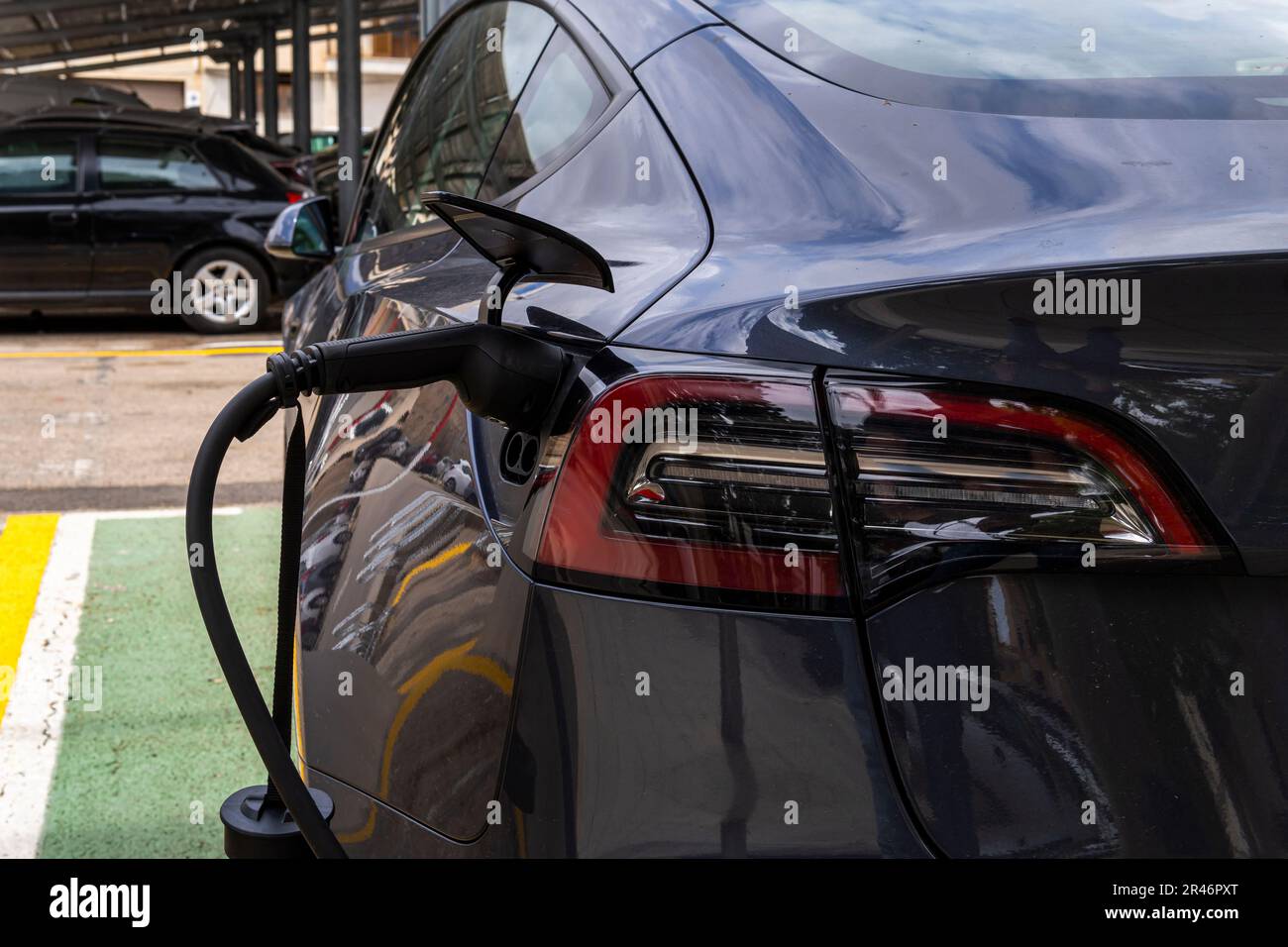 Manacor, Spain; may 06 2023 Dark gray Tesla electric car, recharging