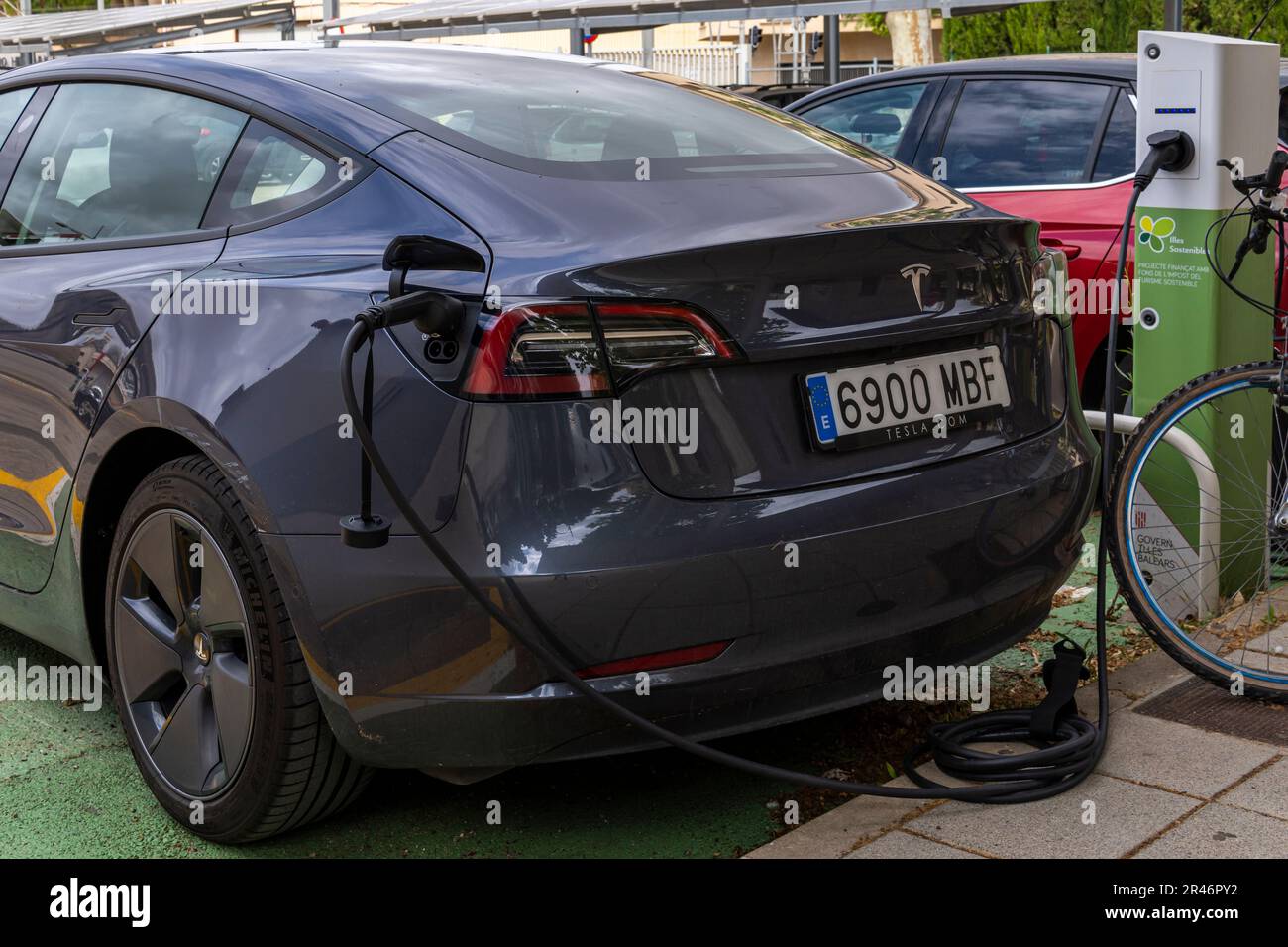 Manacor, Spain; may 06 2023 Dark gray Tesla electric car, recharging at an urban electric