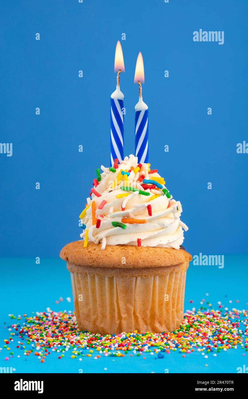 Birthday cake with two candles Blue background Stock Photo Alamy