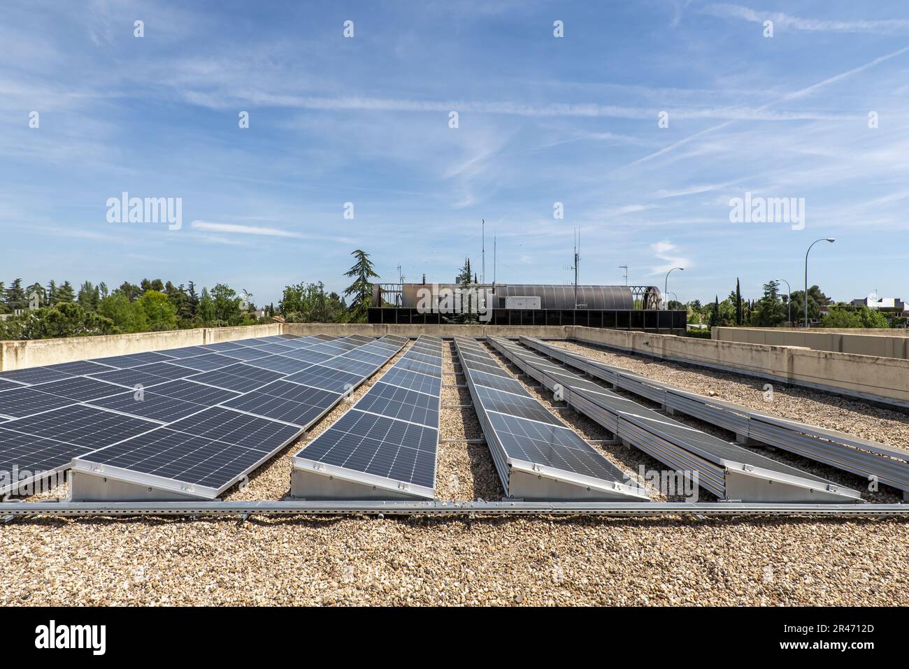 Alignment of recently installed solar panels on the roof of an office building Stock Photo