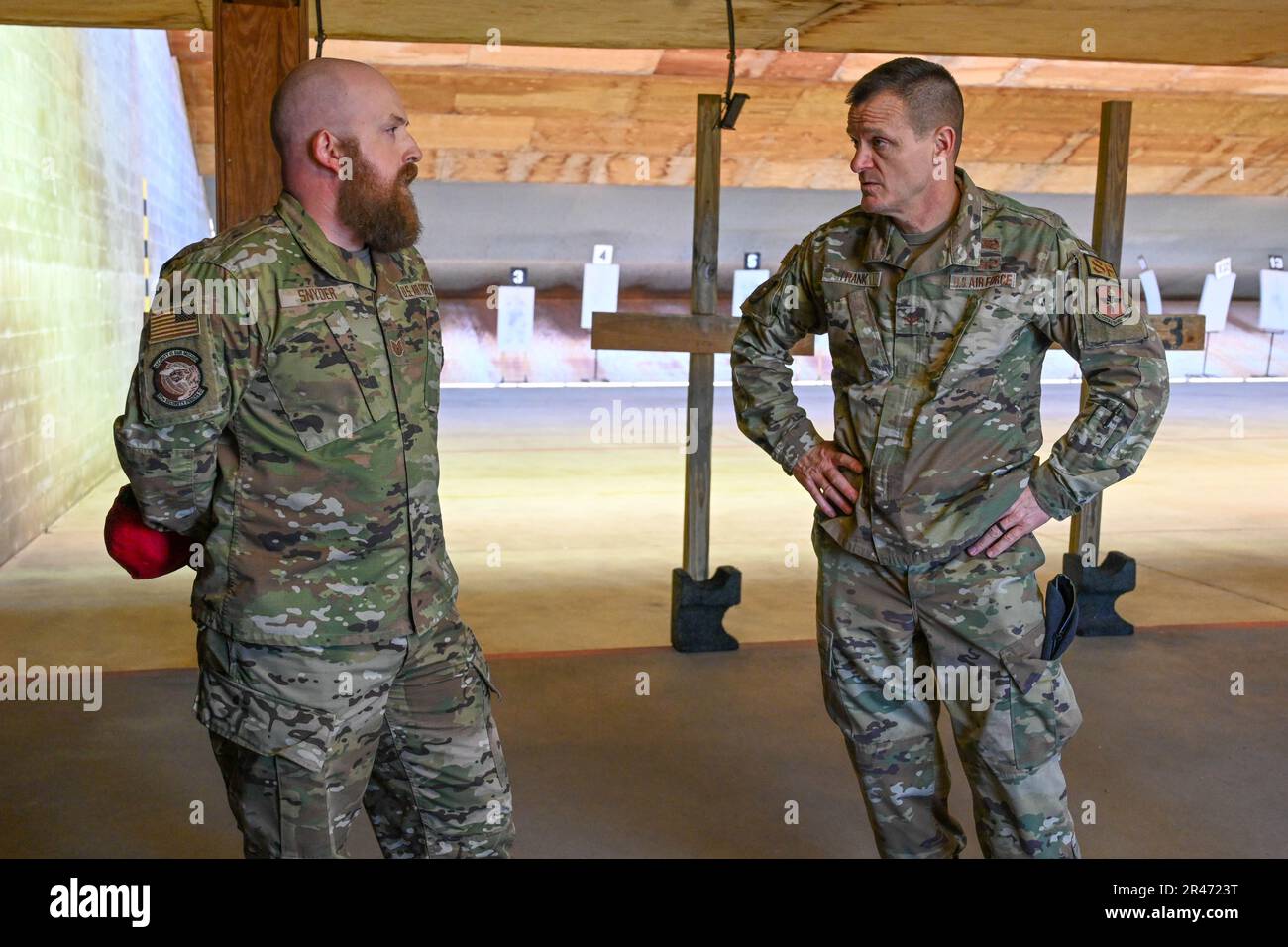 U.S. Air Force Tech. Sgt. Casey Snyder, 97th Security Forces Squadron firearms instructor, talks to Col. Seth Frank, Air Education and Training Command chief of security forces, at Altus Air Force Base, Oklahoma, March 29, 2023. Stock Photo