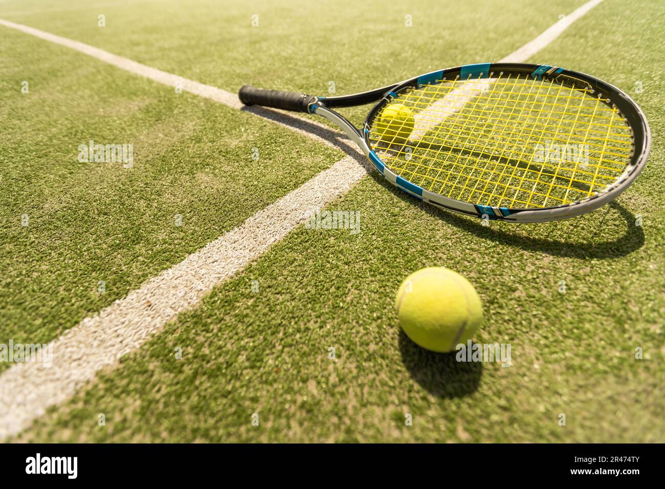 Tennis Bal Racket tennis racket with a tennis ball on a tennis court Stock Photo - Alamy