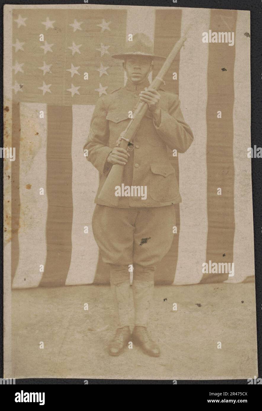 Unidentified African American soldier in uniform and campaign hat with ...
