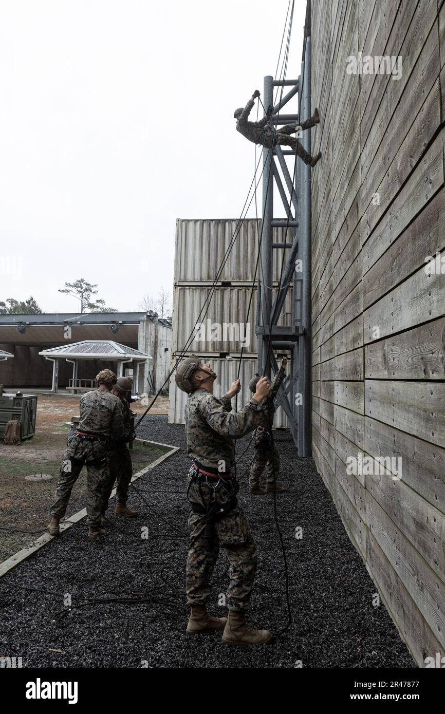 U.S. Marines assigned to II Marine Expeditionary Force, Expeditionary Operations Training Group (EOTG), are evaluated on their proficiency in rappelling during the Assault Climber Course aboard Stone Bay, Marine Corps Base Camp Lejeune, North Carolina, Jan. 19, 2023. Assault Climber Course is an opportunity for the EOTG to train and evaluate the 26th Marine Expeditionary Unit’s ability to complete special individual and collective tasks, and evaluates their ability to conduct assigned mission essential tasks in order to prepare those forces to support the geographic combatant commanders. Stock Photo