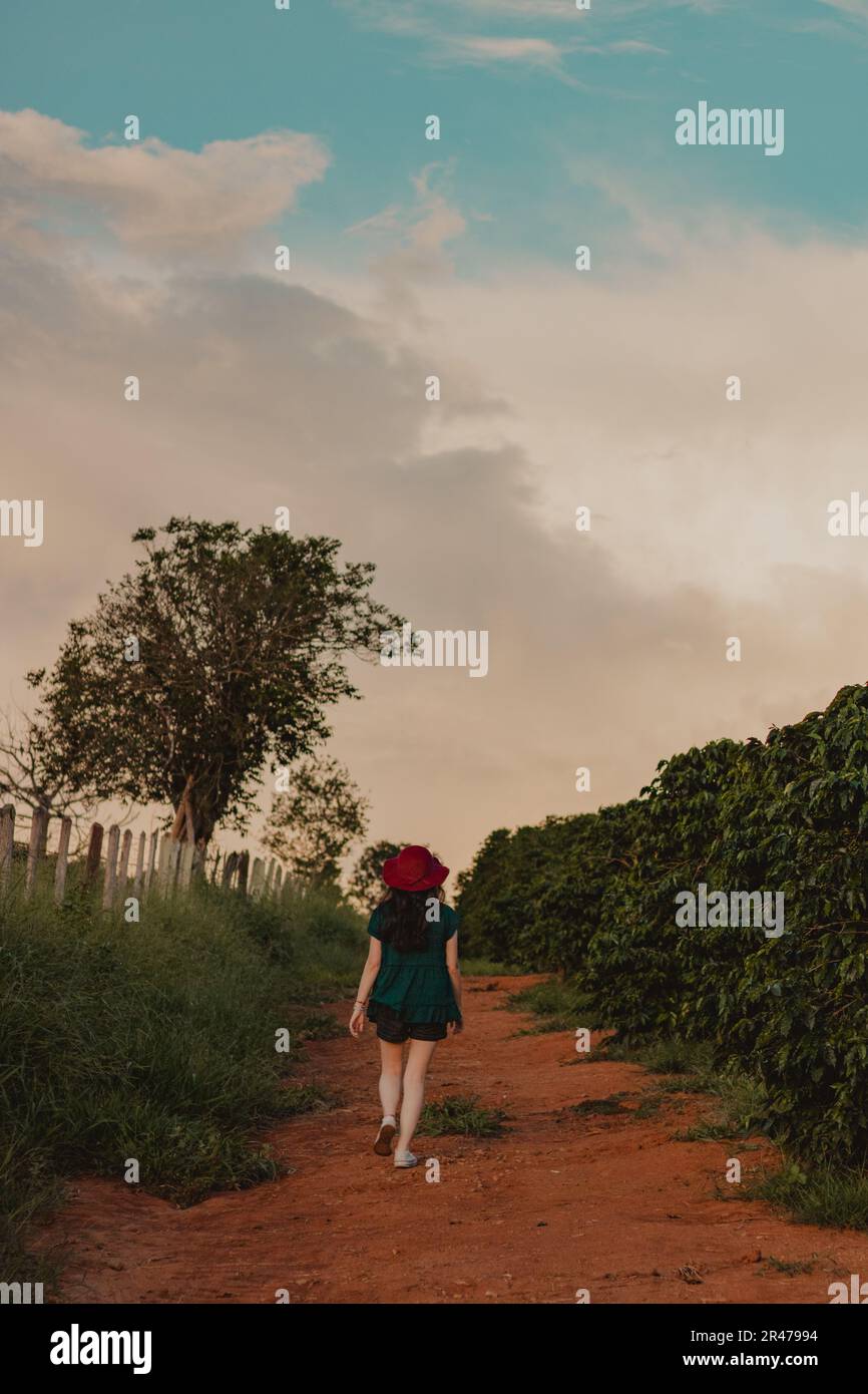 Woman walking away country road hi-res stock photography and images - Alamy