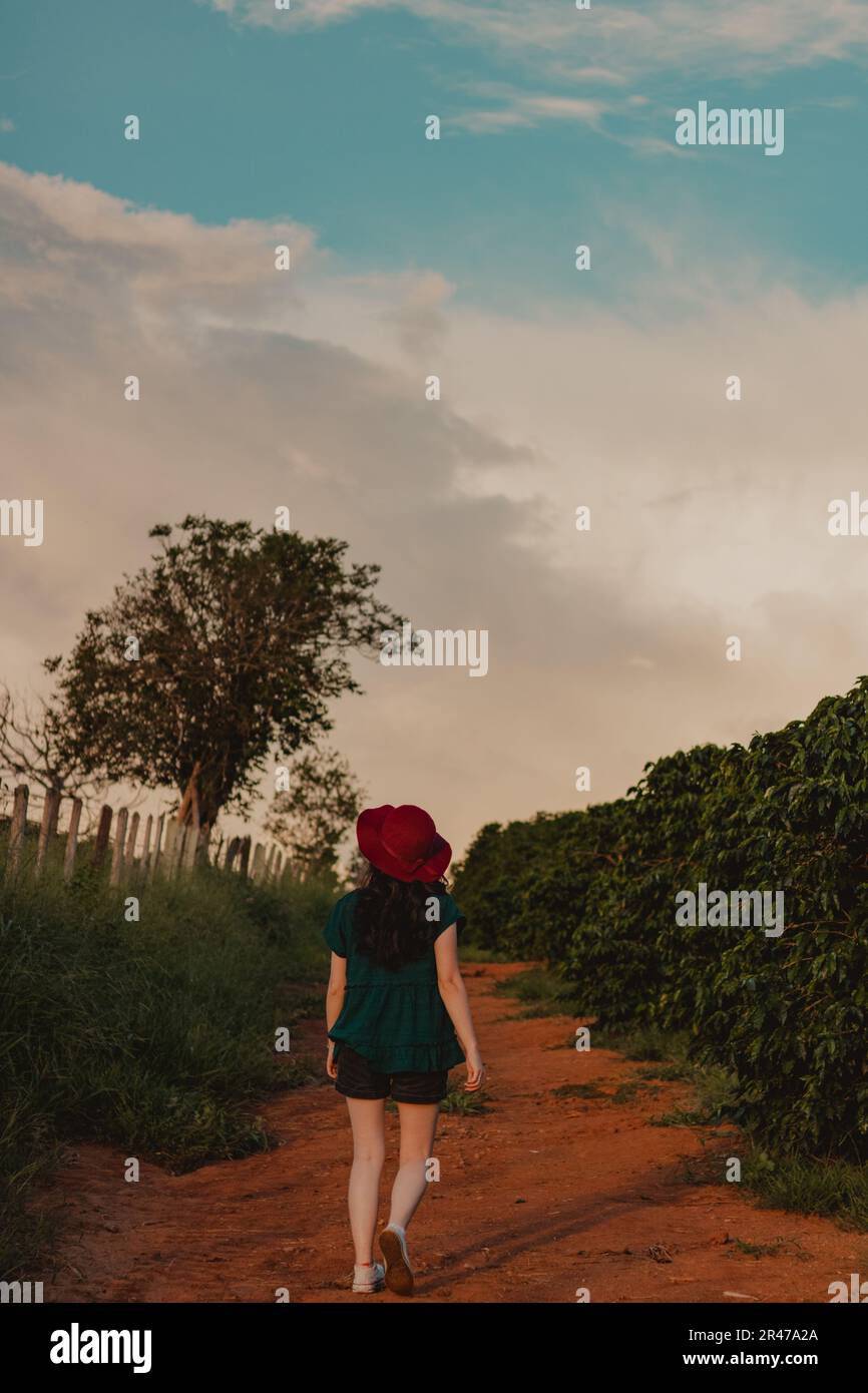 young woman walking in the countryside at dusk Stock Photo