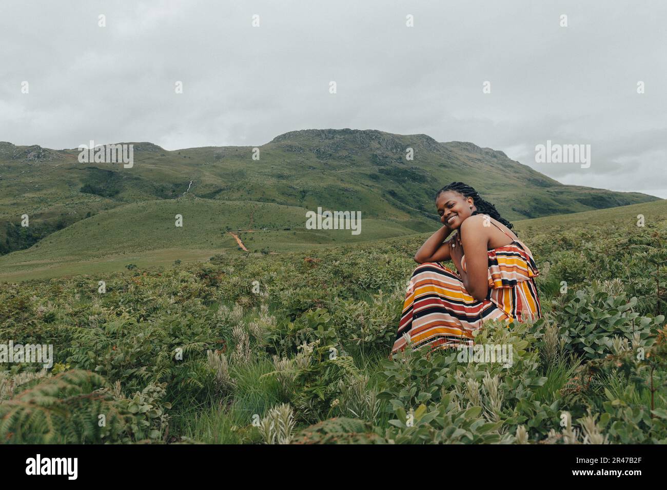 Cheerful african woman in green hi-res stock photography and images - Alamy
