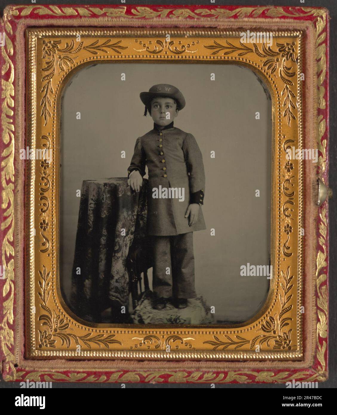 Unidentified young boy in military uniform with ''WR'' on hat, possibly for Washington Rifles Stock Photo