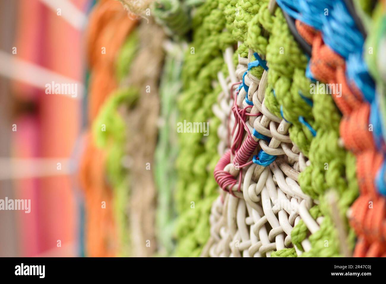 A vibrant, close-up shot of a unique shape created from a variety of colored rope Stock Photo