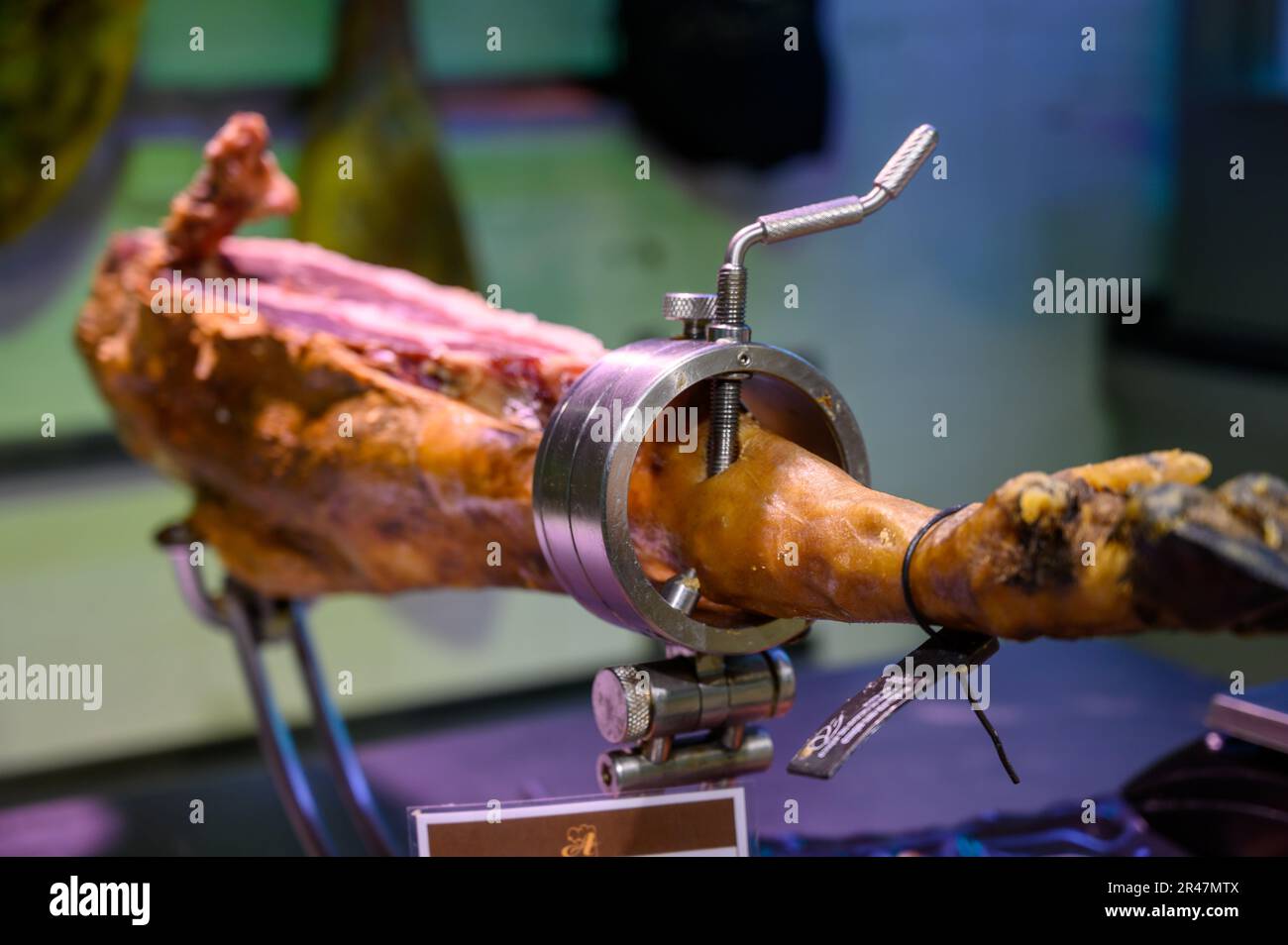 Leg of pork serrano Iberian cured jamon on stand in Spanish butcher's