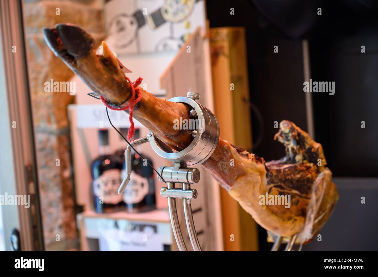 Leg of pork serrano Iberian cured jamon on stand in Spanish butcher's