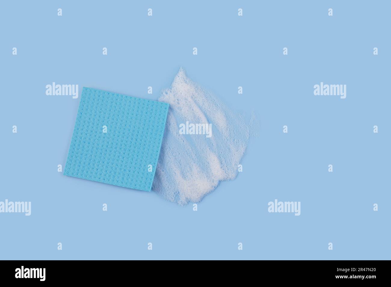 Washing Sponge lying on surface in soapy foam Stock Photo